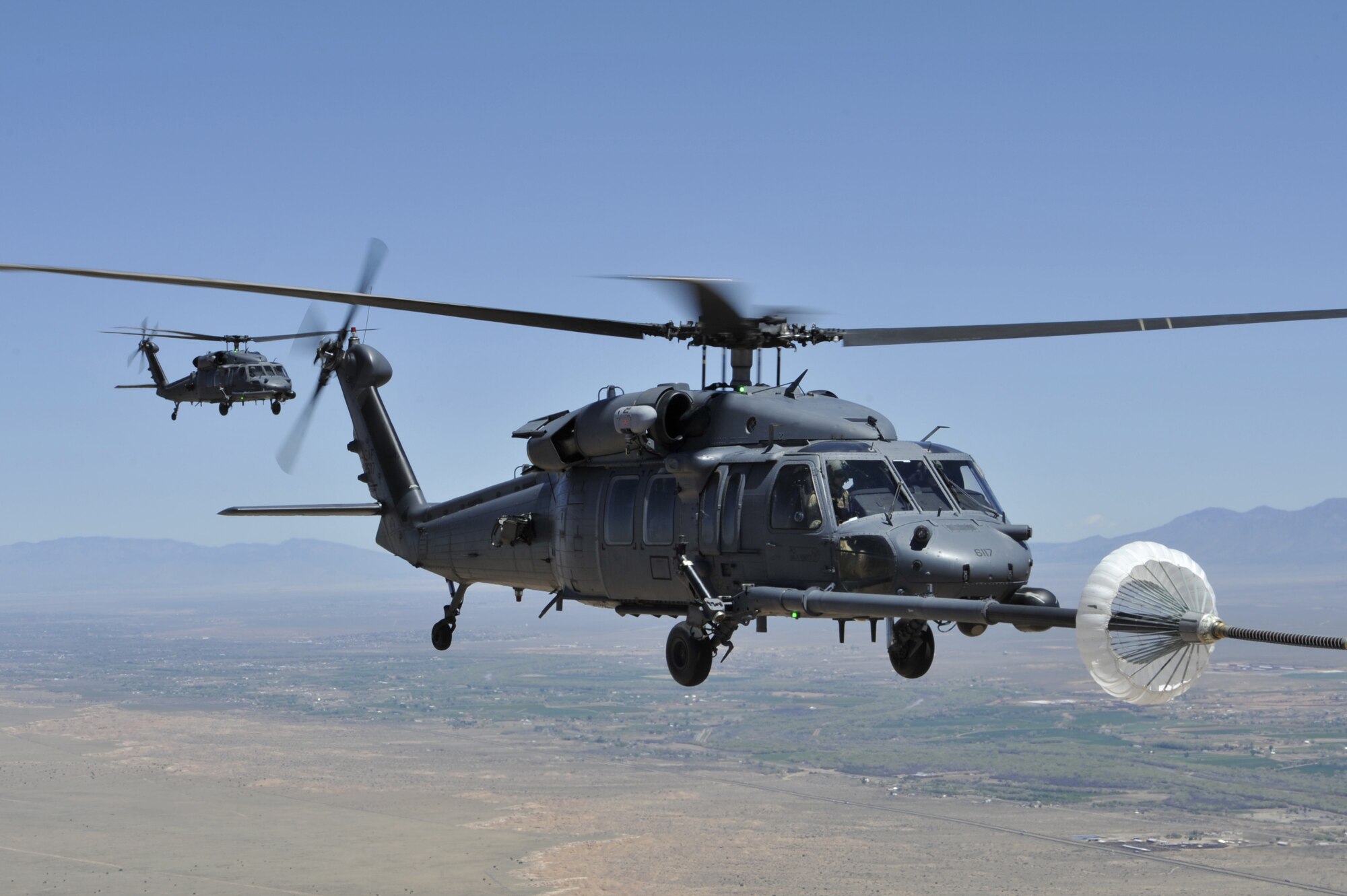 A HH-60G PAVE Hawk helicopter assigned to the 512th Rescue Squadron, Kirtland Air Force Base, N.M., refuels during a training mission over New Mexico, April 19, 2019. The Mission of the 512th RQS is to provide mission-ready UH-1N Huey and HH-60G Pave Hawk aircrew to operational units world-wide. (U.S. Air Force photo by Staff Sgt. Dylan Nuckolls/Released)