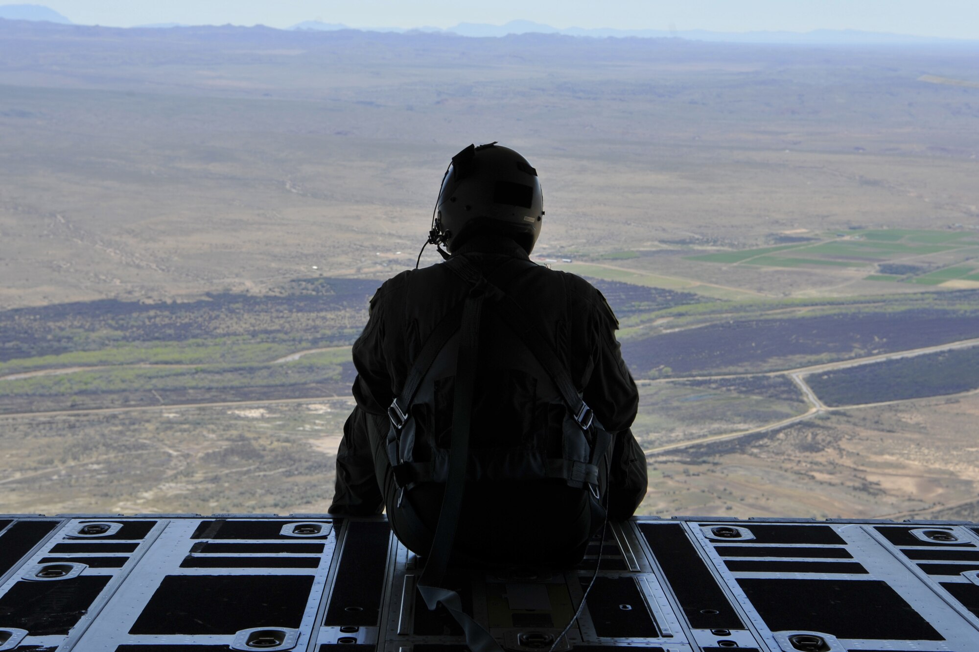 A loadmaster assigned to the 415th Special Operations Squadron, Kirtland Air Force Base, N.M., sits on the ramp of an HC-130J Combat King II during a training mission over New Mexico, April 19, 2019. The 415th SOS trains special operations and combat rescue aircrew for the MC-130J Commando II and HC-130J Combat King II. (U.S. Air Force photo by Staff Sgt. Dylan Nuckolls/Released)