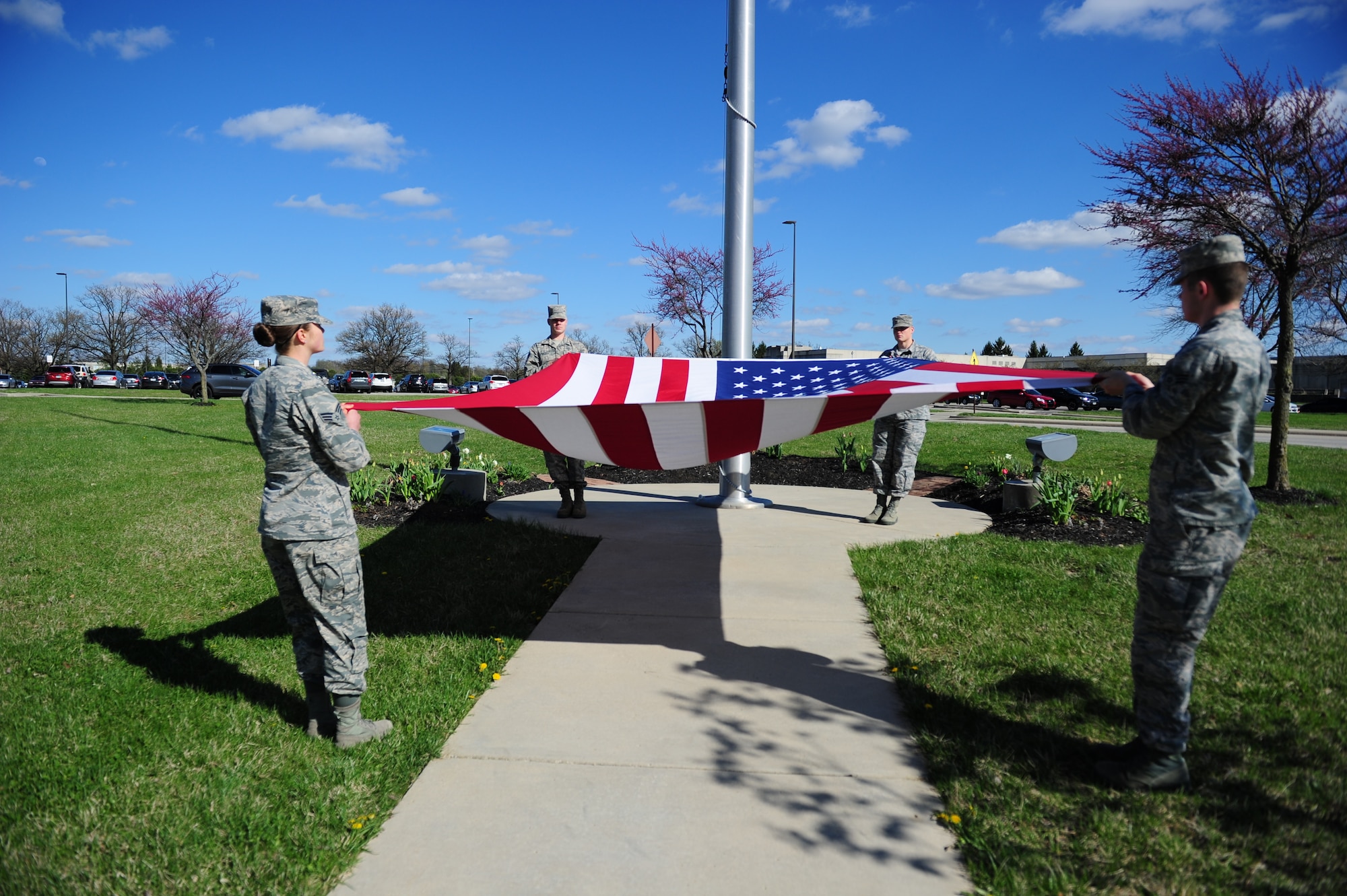 Members of the Geospatial and Signatures Intelligence Group flag detail prepare to fold a U.S. flag during a retreat ceremony at the National Air and Space Intelligence Center on April 15. The event marked the anniversary of the center’s transformation into a wing structure, a move that resulted in the activation of the Air Force’s first set of intelligence analysis groups and squadrons. (U.S. Air Force photo by Senior Airman Michael Hunsaker)