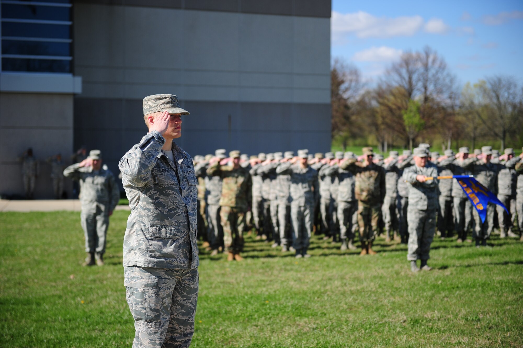 Staff Sgt. Christopher Krause, Persistent Infrared Analysis Squadron infrared analysis supervisor, salutes during a retreat ceremony at the National Air and Space Intelligence Center on April 15. The event marked the anniversary of the center’s transformation into a wing structure, a move that resulted in the activation of the Air Force’s first set of technical intelligence analysis groups and squadrons. (U.S. Air Force photo by Senior Airman Michael Hunsaker)