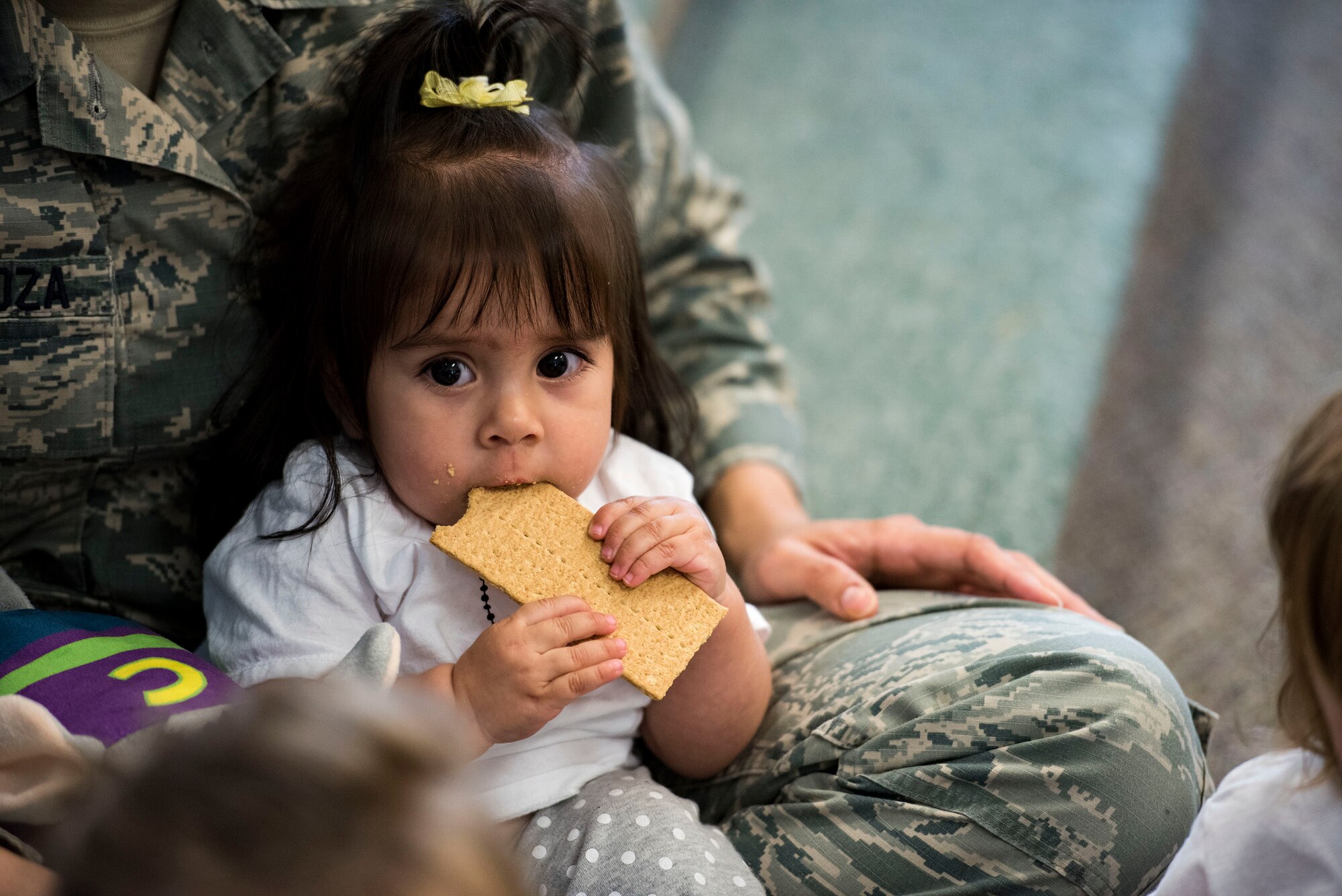 A child eats a graham cracker during the Teddy Bear Picnic, April 26, 2019, at Moody Air Force Base, Ga. The Child Development Center hosted the event in support of the Month of the Military Child in April. (U.S. Air Force photo by Senior Airman Erick Requadt)