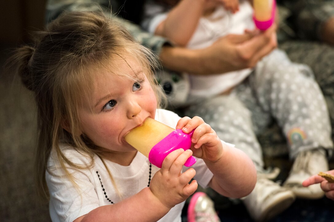 A child eats a popsicle during the Teddy Bear Picnic, April 26, 2019, at Moody Air Force Base, Ga. The Child Development Center hosted the event in support of the Month of the Military Child in April. (U.S. Air Force photo by Senior Airman Erick Requadt)