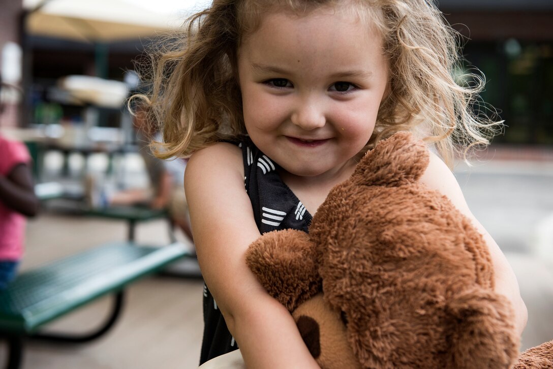 A child poses for a photo during the Teddy Bear Picnic, April 26, 2019, at Moody Air Force Base, Ga. The Child Development Center hosted the event in support of the Month of the Military Child in April. (U.S. Air Force photo by Senior Airman Erick Requadt)