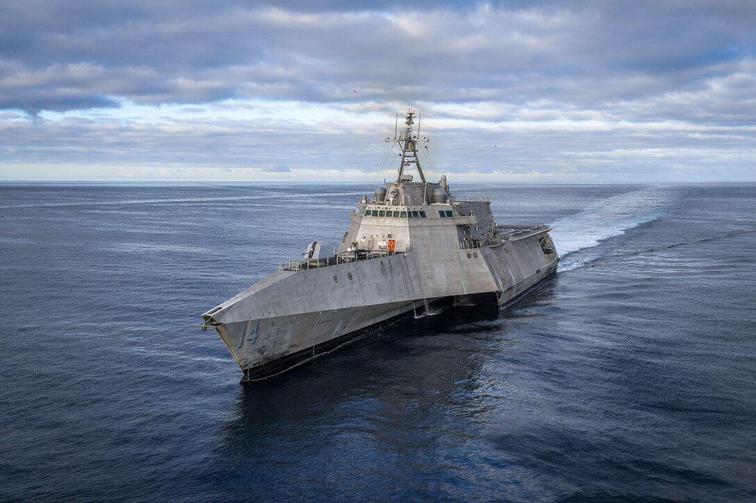 A military ship moves through the ocean.