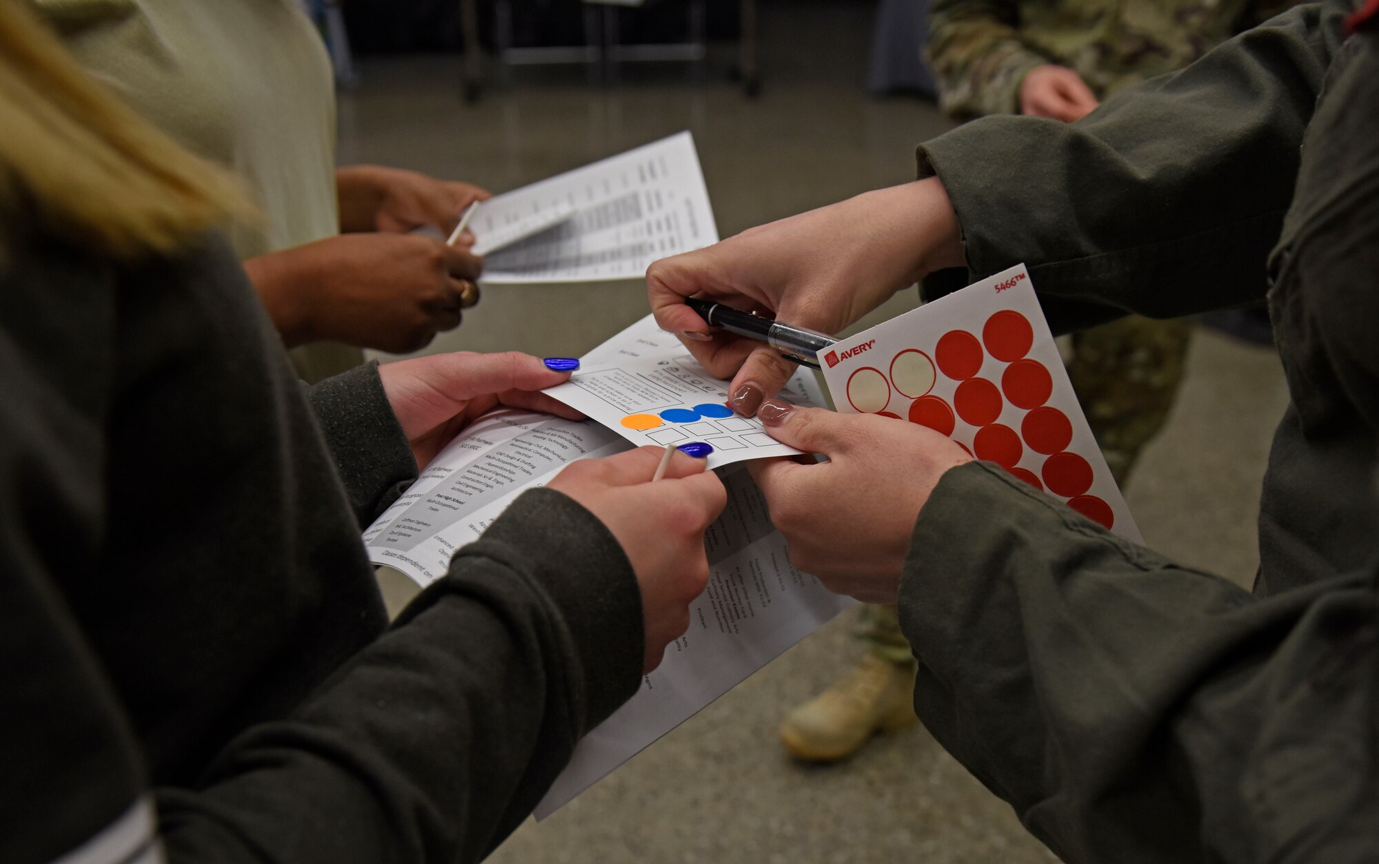 U.S. Air Force Senior Airman Megan Hatch, 93rd Air Refueling Squadron boom operator, places a sticker on a student’s job fair booth tracker during the annual NEWTech Skills Center job fair in Spokane, Washington, April 24, 2019. The event hosted several science, technology, engineering, art and math careers with industry professional to showcase the ins-and-outs of their job. (U.S. Air Force photo by Senior Airman Jesenia Landaverde)