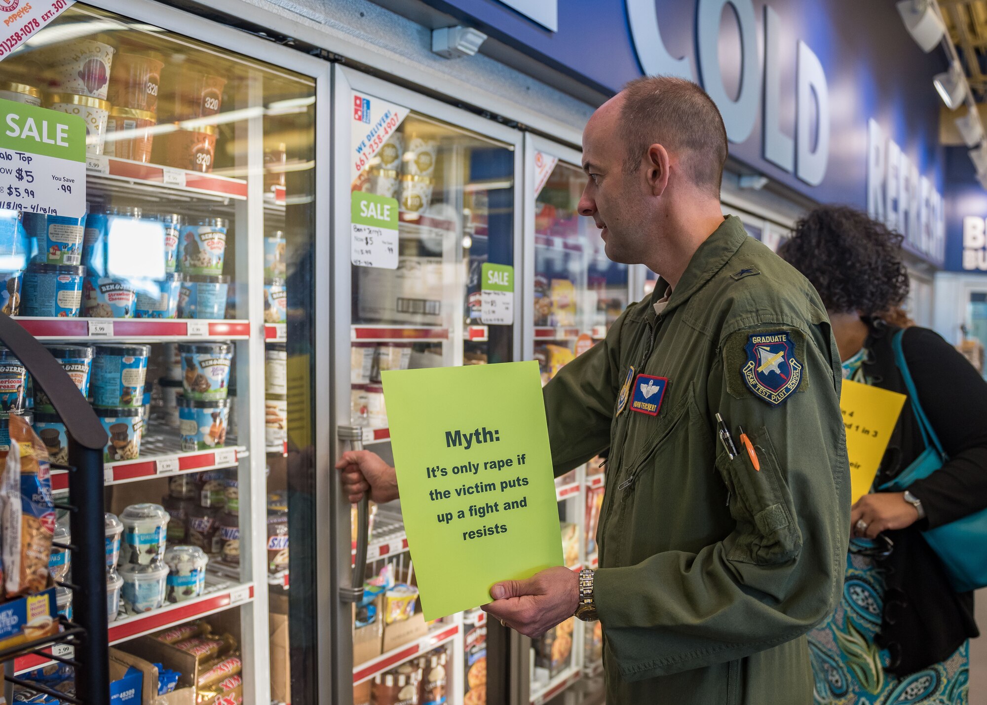 Brig. Gen. E. John Teichert, 412th Test Wing commander, participates in a Sexual Assault Awareness and Prevention Month Freeze Flash Mob, April 16. Team Edwards members staged the freeze mobs at certain locations around the base and held signs regarding facts about sexual assault. (U.S. Air Force photo by Matt Williams)