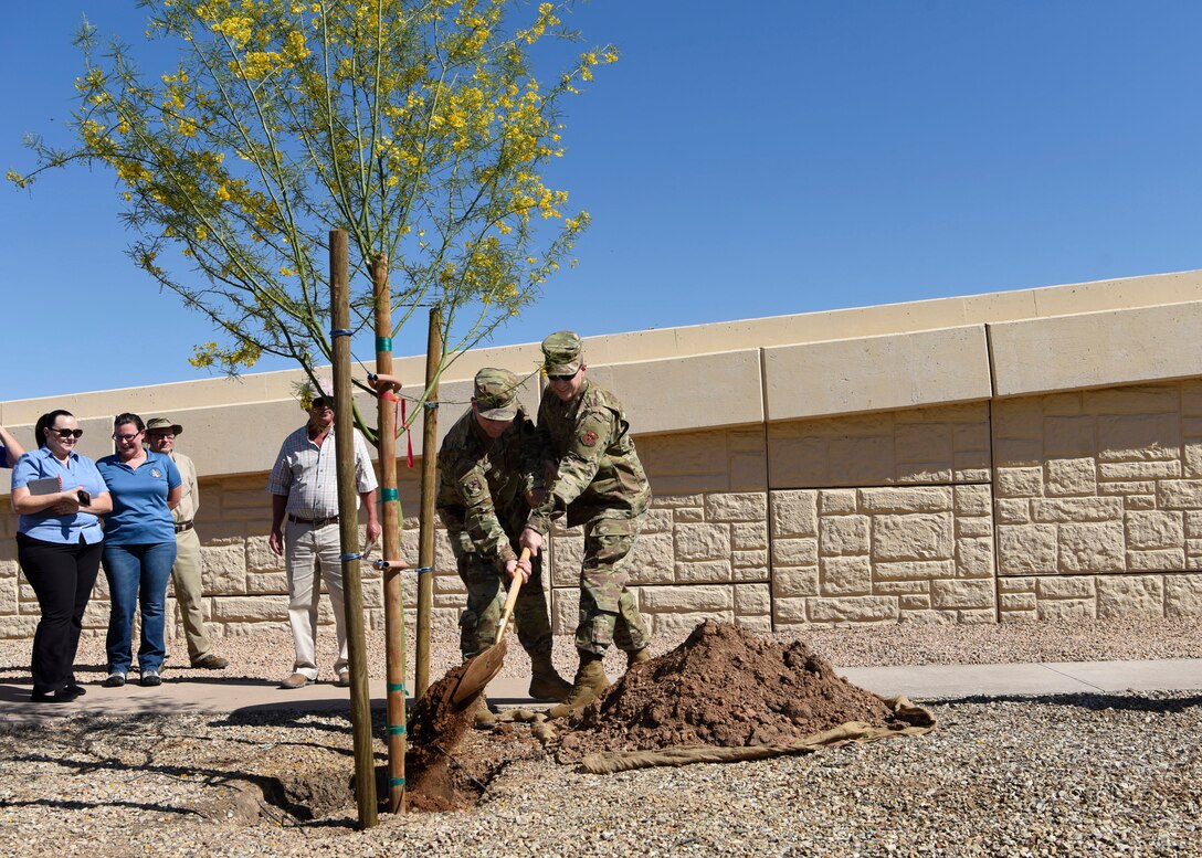 Lt. Col. Paul Fredin, 56 Civil Engineering Squadron commander, and Chief Master Sgt. Jeffrey Martin, 56th CES superintendent, plant a tree for Arbor Day April 26, 2019, at Luke Air Force Base, Ariz. Arbor Day is recognized as a national holiday, celebrating the importance of trees and plant life within the ecosystem and promotes planting and caring for trees. (U.S. Air Force photo by Airman 1st Class Zoie Cox)
