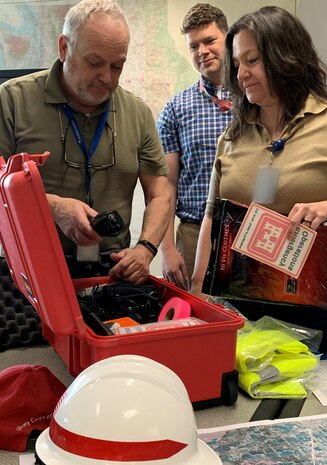 Walla Walla District Disaster Response Manager Jeff Stidham (left) issues a deployment kit on April 26 from the District’s Emergency Operations Center for flood-fight specialists Kevan Schneidmiller (center) and Joy Hartl (right) to use while assessing levee conditions in Madison and Jefferson counties, Idaho. The two engineers will deploy on April 28 to assist local levee sponsors with identifying areas that may be at risk of damage from high river flows.