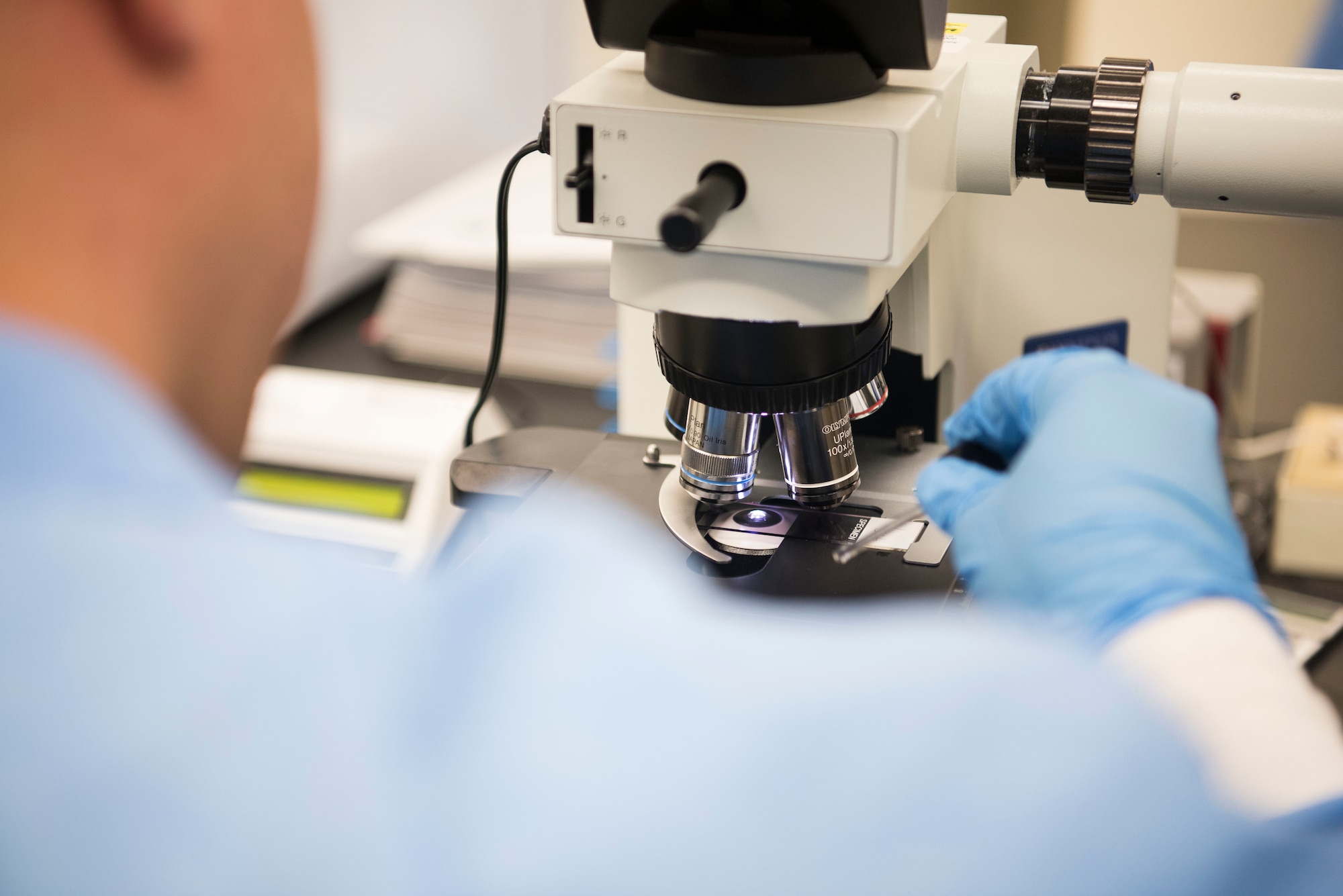U.S. Air Force Senior Airman Carlos Berrera, 30th Medical Support Squadron laboratory technician, adjusts slides in a microscope at Vandenberg Air Force Base, California, April 24, 2019. As one of the first steps in effective care, the 30th MDSS Laboratory provides diagnostic information to improve diagnoses. (U.S. Air Force photo by Airman 1st Class Hanah Abercrombie)