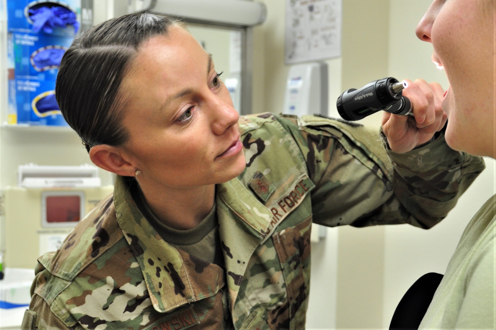 U.S. Air Force Capt. Shauna Sokolowski, 359th Medical Group Family Health clinical nurse, checks the inside of a simulated patient’s mouth at Joint Base San Antonio-Randolph, Texas, April 23, 2019. National Nurses Week takes place May 6-12, Florence Nightingale's birthday. (U.S. Air Force photo by Tech. Sgt. Ave I. Young)