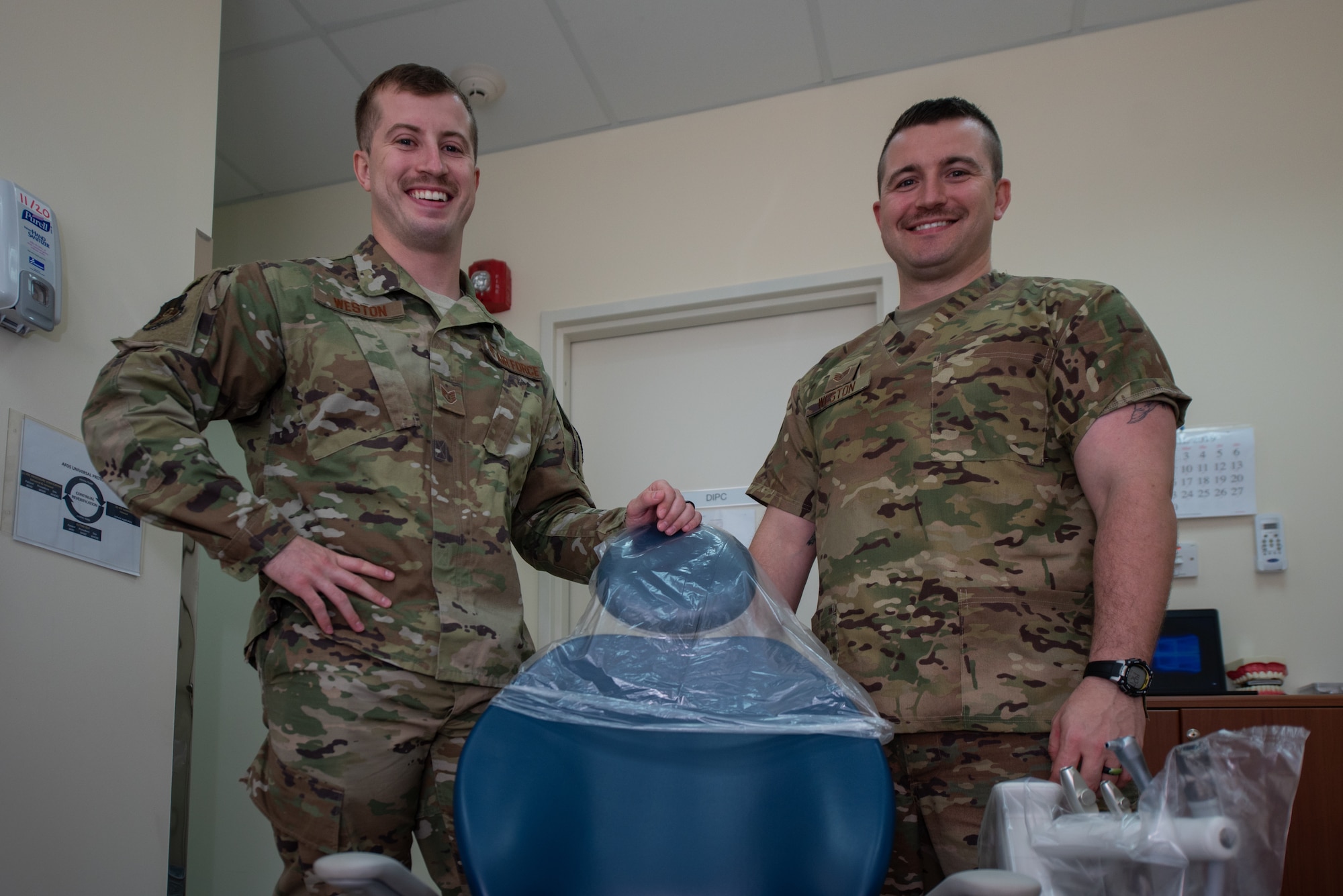 Staff Sgt. Cameron Weston, left, 380th Expeditionary Aircraft Maintenance Squadron F-35 Lightning II Egress technician, and Staff Sgt. Garrett Weston, 380th Expeditionary Medical Group dental element noncommissioned officer-in-charge, pose for a photo April 23, 2019, at Al Dhafra Air Base, United Arab Emirates.