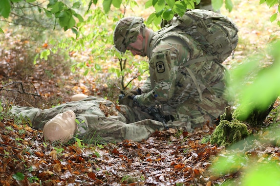 U.S. Army Reserve Sgt. Konner Klein, a supply sergeant with Charlie Company, 457th Civil Affairs Battalion, 361st Civil Affairs Brigade, 7th Mission Support Command (MSC), Wiesbaden, Germany, stops to administer first aid while maneuvering the obstacle course during the 7th MSC Best Warrior Competition (BWC) in Kaiserslautern, Germany, April 26, 2019. BWC is an annual event designed to test the physical fitness, military knowledge, marksmanship, endurance and land navigational skills of each competitor. (U.S. Army Reserve photo by Spc. Terry Cunningham, 221st Public Affairs Detachment)