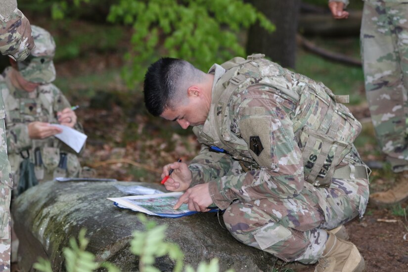 U.S. Army Reserve Staff Sgt. Khristopher Copple, an air missile defense operator with the 2500th Digital Liaison Detachment, 7th Mission Support Command (MSC), Vicenza, Italy, plots points on his map before maneuvering the land navigation course during the 7th MSC Best Warrior Competition (BWC) in Kaiserslautern, Germany, April 26l, 2019. BWC is an annual event designed to test the physical fitness, military knowledge, marksmanship, endurance and land navigational skills of each competitor. (U.S. Army Reserve photo by Sgt. Christopher Stelter, 221st Public Affairs Detachment)