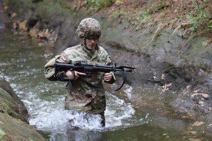 U.S. Army Reserve Spc. Yannik Marazia, a heavy wheeled vehicle operator with the 510th Regional Support Group, 7th Mission Support Command (MSC), Kaiserslautern, Germany, wades through a trench while maneuvering the obstacle course during the 7th MSC Best Warrior Competition (BWC) in Kaiserslautern, Germany, April 26, 2019. BWC is an annual event designed to test the physical fitness, military knowledge, marksmanship, endurance and land navigational skills of each competitor. (U.S. Army Reserve photo by Sgt Christopher Stelter, 221st Public Affairs Detachment)