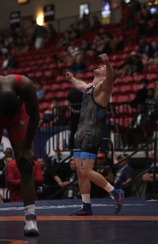 Marine Sgt. Raymond Bunker accepts victory after wrestling against Ravaughn Perkins during the US Marine Corps Open Wrestling Championships in Las Vegas, April 26, 2019.  USA Wrestling has more than 226,000 members. Each year, USA Wrestling charters over 4,500 wrestling clubs and sanctions over 2,100 local, state, regional and national competitions. US Marines partner with and attend organizational championships such as the US Marine Corps Open Championships to support student athletes, coaches and their communities, to inform young people about opportunities within the Marine Corps, and to continue to foster the fighting spirit that Marines and athletes share. (US Marine Corps photo by Cpl. Naomi May)
