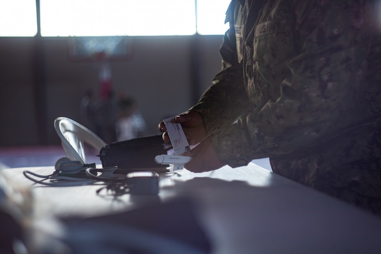 A Sailor sets up a table for the medical station at Ponce, Puerto Rico, April 26, 2019, during Innovative Readiness Training Puerto Rico. Marine Forces Reserve Sailors are working jointly with several National Guard and Reserve units from across the nation to provide medical care in Puerto Rico during a two-week medical exercise.