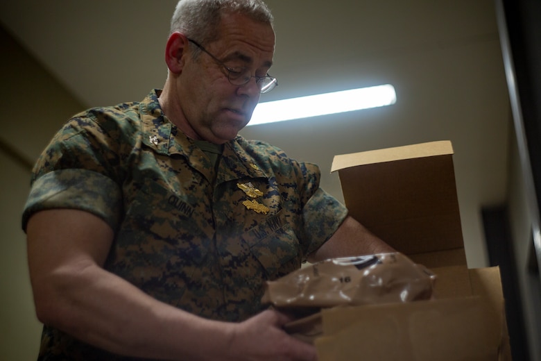 Navy Capt. James T. Quinn, an administration officer and pediatric dentist with 4th Dental Battalion, 4th Marine Logistics Group, Marine Forces Reserve, grabs a Meal, Ready to Eat for lunch at Ponce, Puerto Rico, April 26, 2019, during Innovative Readiness Training Puerto Rico. MARFORRES Sailors are working jointly with several National Guard and Reserve units from across the nation to provide medical care in Puerto Rico during a two-week medical exercise.