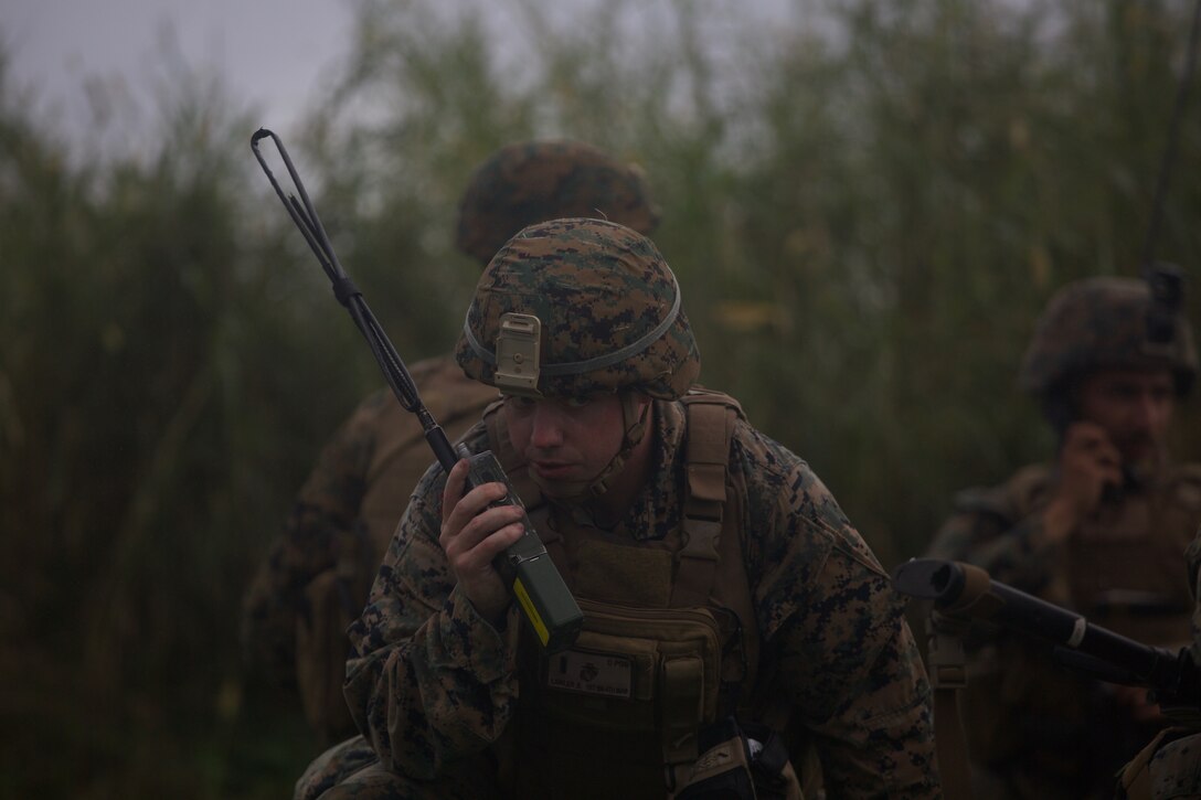 A Marine with Charlie Company, Battalion Landing Team, 1st Battalion, 4th Marines, speaks into a handheld radio during a simulated helicopter raid as part of the 31st Marine Expeditionary Unit’s MEU Exercise at Ie Shima Training Facility, Okinawa, Japan, Dec. 11, 2018. BLT 1/4 is the Ground Combat Element for the 31st MEU. MEUEX is the first in a series of pre-deployment training events that prepare the 31st MEU to deploy at a moment’s notice. The 31st MEU, the Marine Corps' only continuously forward-deployed MEU, provides a flexible force ready to perform a wide-range of military operations across the Indo-Pacific region.