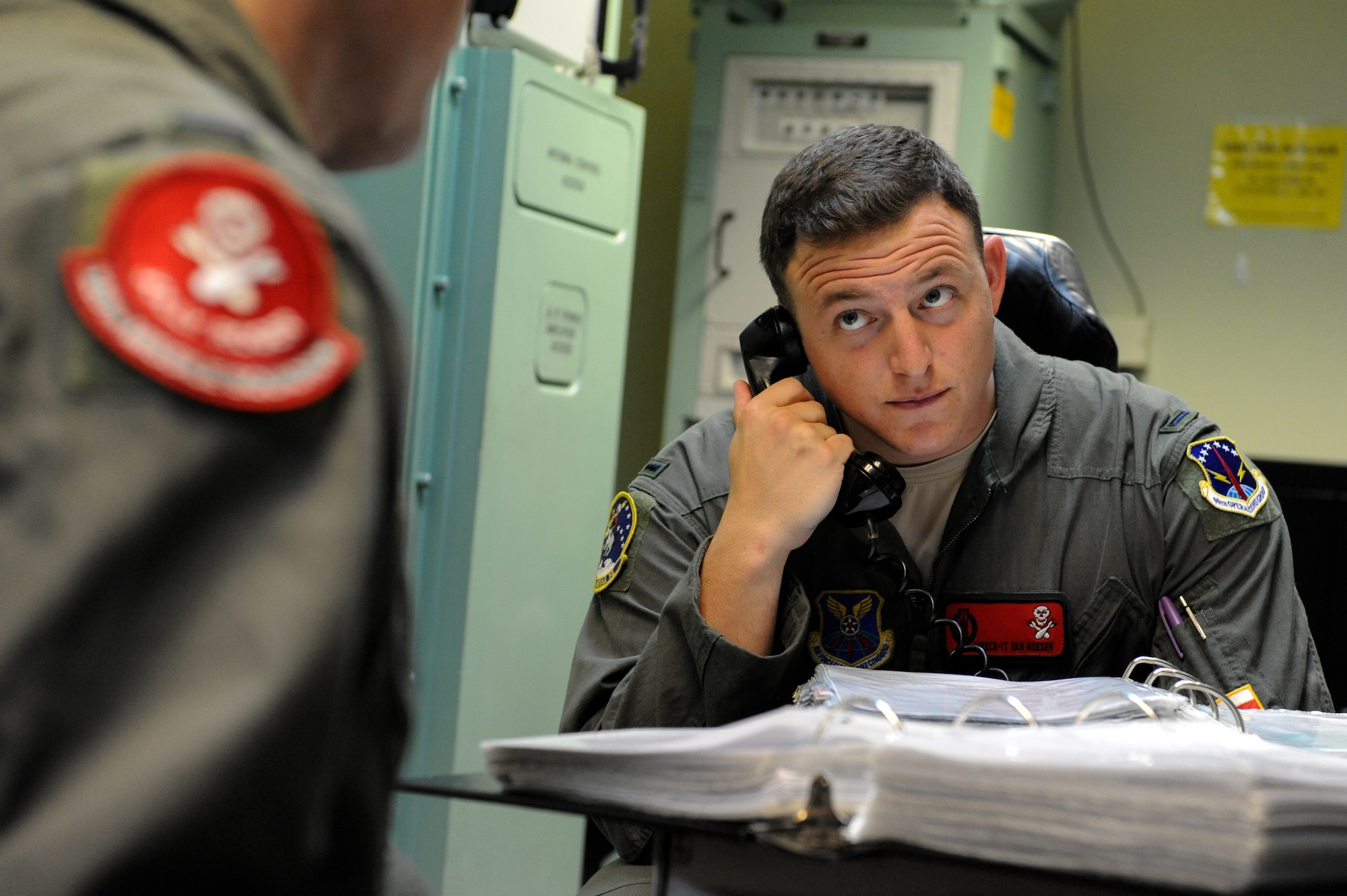 1st Lt. Austin Van Hoesen, 320th Missile Squadron assistant flight commander, holds a conference call to direct maintenance during training on F.E. Warren Air Force Base, Wyoming, April 25, 2019. The Air Force Association awarded Van Hoesen and 1st Lt. Jedediah Simpson, 320 MS missileer, the 2019 Gen. Thomas S. Power Outstanding Missile Crew Award. (U.S. Air Force photo by Joseph Coslett)