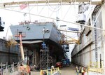 Conducting maintenance on the underwater hull.