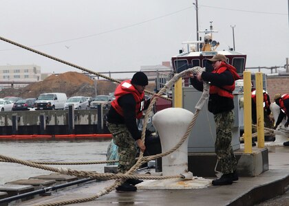 Conducting maintenance on the underwater hull.