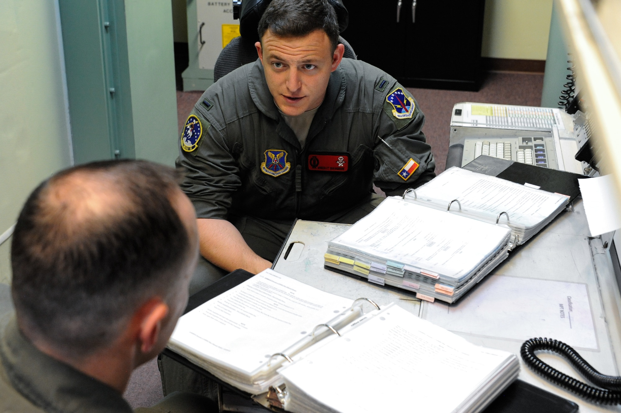 1st Lt. Austin Van Hoesen, 320th Missile Squadron assistant flight commander, debriefs maintenance actions with 1st Lt. Jedediah Simpson, 320 MS missileer, on F.E. Warren Air Force Base, Wyoming, April 25, 2019. The Air Force Association awarded Van Hoesen and Simpson the 2019 Gen. Thomas S. Power Outstanding Missile Crew Award. (U.S. Air Force photo by Joseph Coslett)