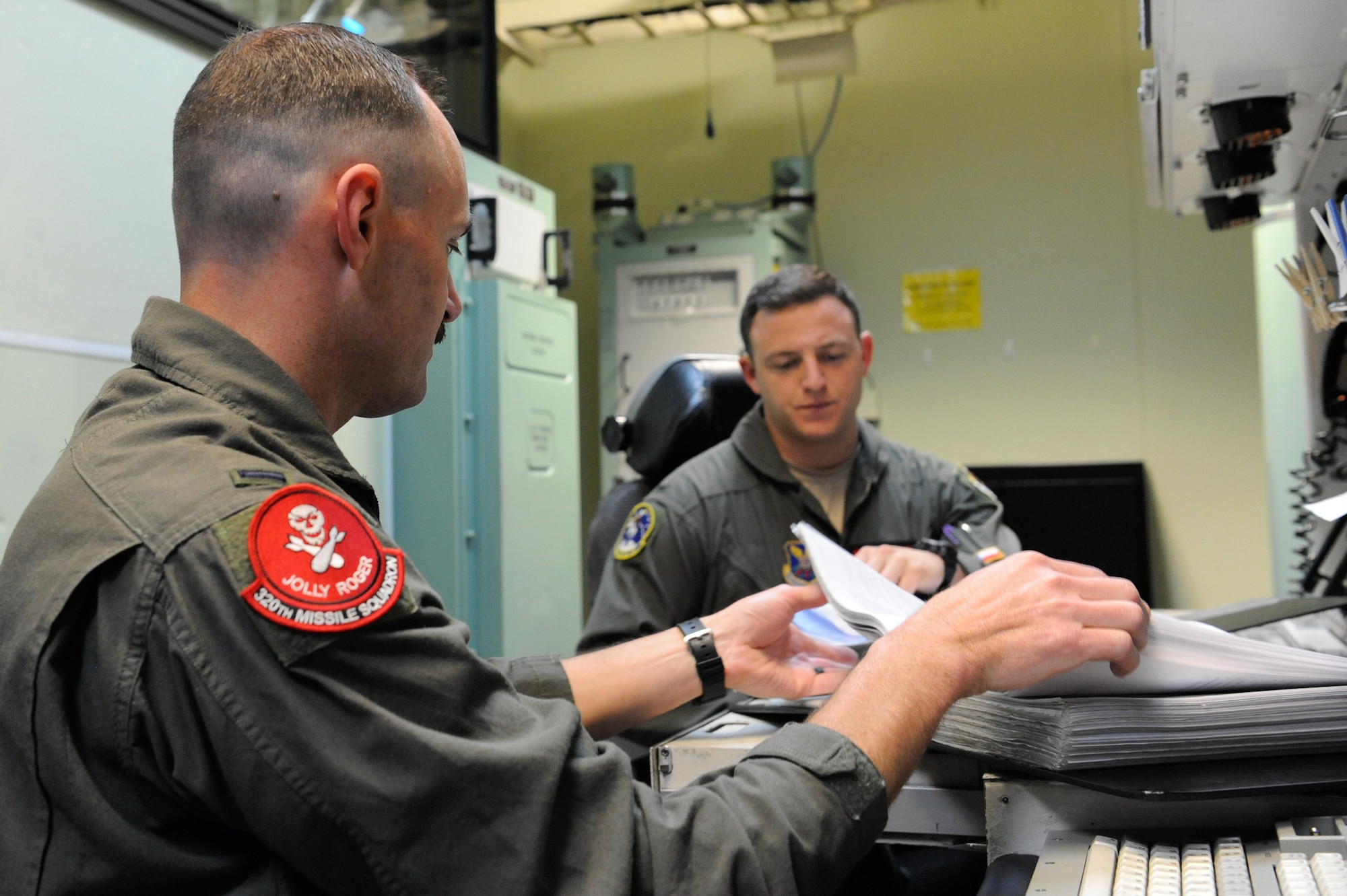 1st Lt. Jedediah Simpson, 320th Missile Squadron missileer, opens his procedural checklist to begin training on F.E. Warren Air Force Base, Wyoming, April 25, 2019. The Air Force Association awarded Simpson and 1st Lt. Austin Van Hoesen, 320 MS assistant flight commander, the 2019 Gen. Thomas S. Power Outstanding Missile Crew Award. (U.S. Air Force photo by Joseph Coslett)