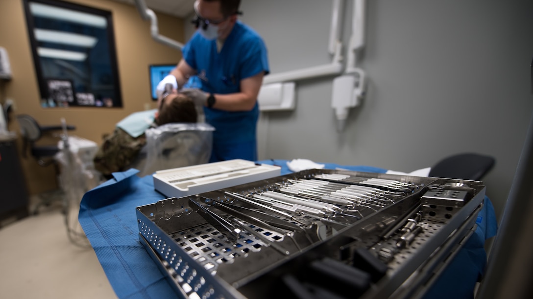 U.S. Air Force Capt. Matthew Sherwood, 2nd Dental Squadron dental resident, evaluates his patient for the insertion of a prosthetic molar at the Barksdale Dental Clinic, Louisiana, April 4, 2019. A dental implant consists of a metal post surgically implanted into the jaw, an abutment that serves as an extension of the post, and the prosthetic tooth and attaches to the abutment piece. (U.S. Air Force photo by Tech. Sgt. Daniel Martinez)