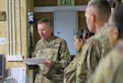Chief Warrant Officer 3 Kim Ralston, 184th Sustainment Command, briefs members of the 1st Theater Sustainment Command’s Syrian Logistics Cell in Erbil, Iraq, April 24, 2019.
