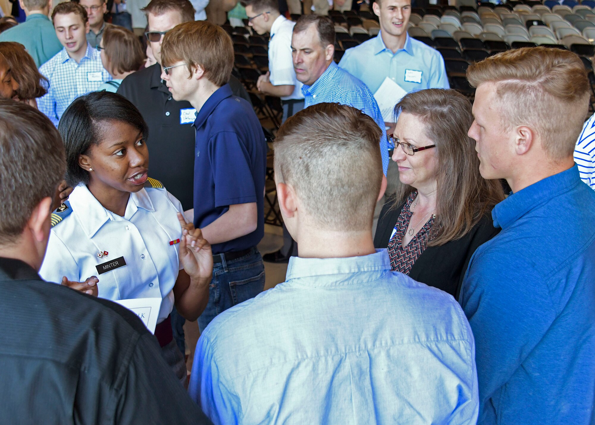 A United States Military Academy student talks with a high school student about what it is like to attend a military academy at Dobbins Air Reserve Base, Ga. on April 27, 2019. Dobbins hosted the 20th annual Academy Day, where representatives from all the military service academies come to talk with potential attendees, and students come to meet congressional representatives (U.S. Air Force photo by Tech. Sgt.  Miles Wilson).