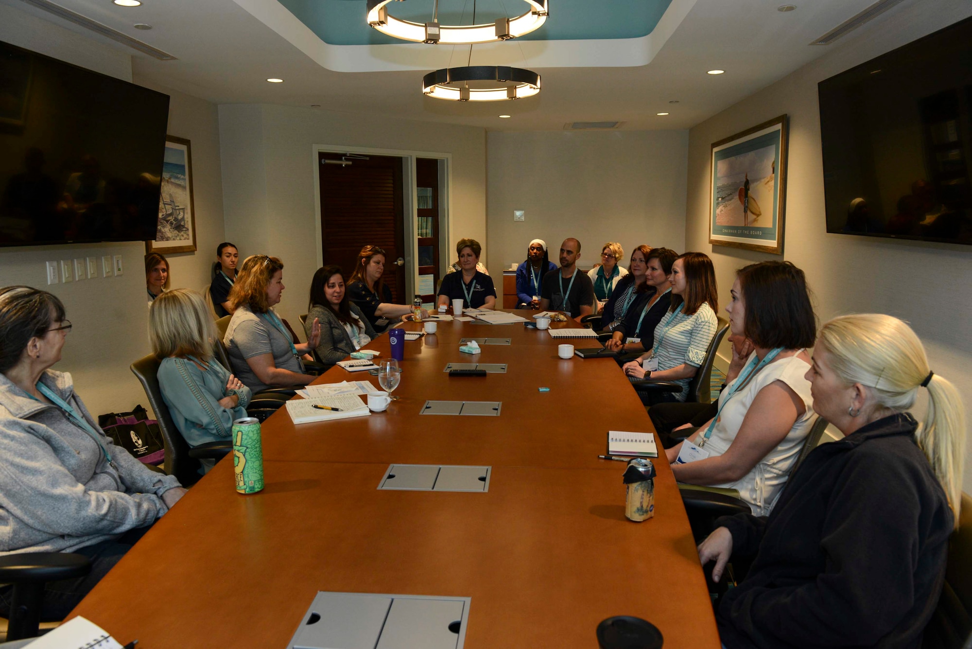 A group of people sitting at a conference table in a conference room.