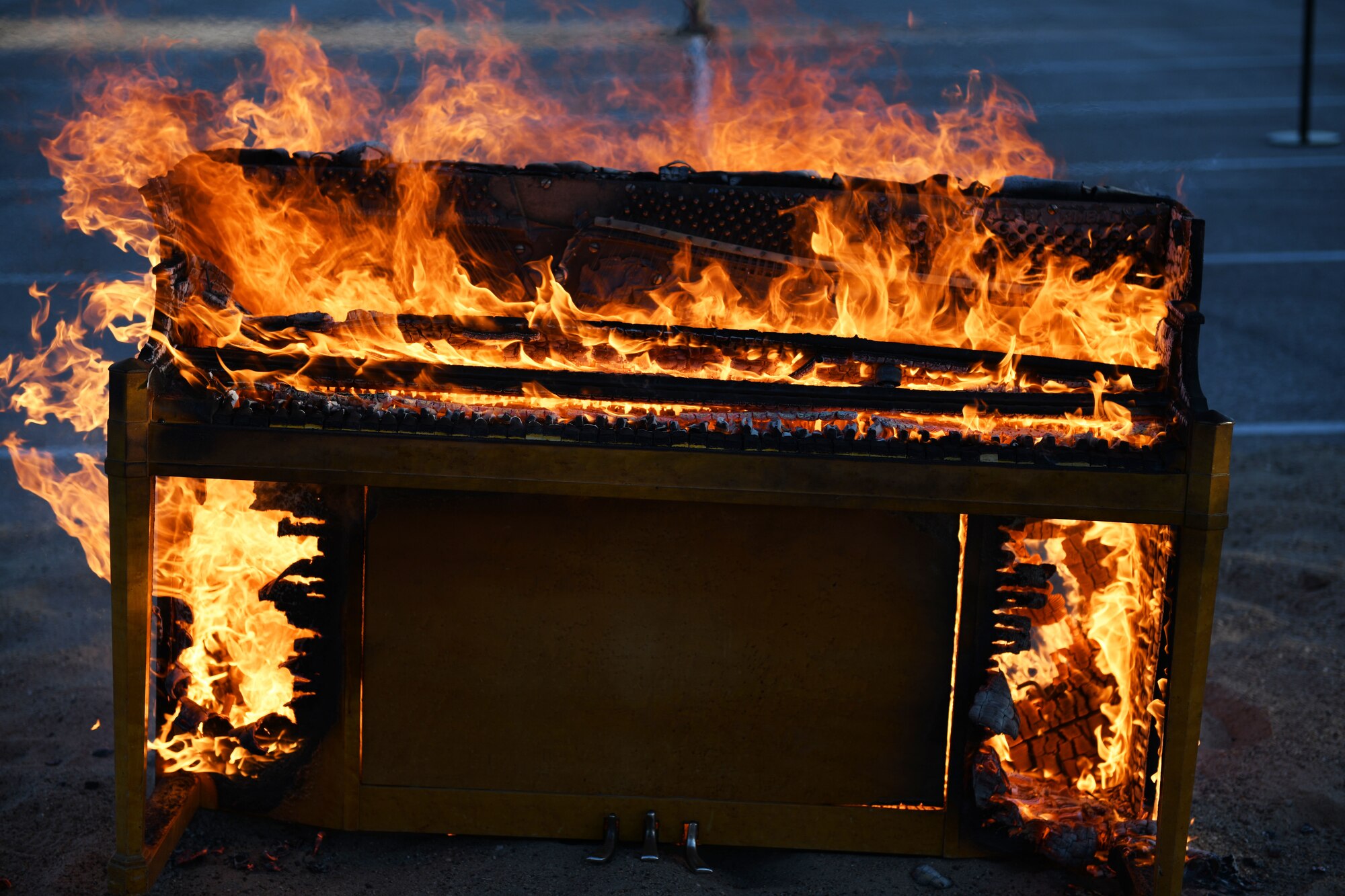 A piano burns at Ellsworth Air Force Base, S.D., April 18, 2019, in memory of retired Lt. Col. Richard “Dick” E. Cole, a B-25 Mitchell pilot who died on April 9. Cole was the last surviving member of the Dolittle Raid – a bombing mission over Japan during World War II. Cole’s accomplishments were celebrated at Ellsworth AFB on the 77th anniversary of the Raid. Piano burning is a long-standing tradition the military performs to say goodbye to a comrade who has died. It is not only a solemn occasion but also a celebration of a service member’s life. (U.S. Air Force photo by Airman 1st Class Thomas Karol)