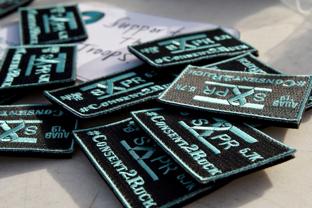 Sexual assault and prevention response patches are laid on a table for individuals who complete the SAPR ruck march on April 26, 2019 at Al Udeid Air Base, Qatar. More than 200 people gathered to ruck 6.7 kilometers to raise awareness for sexual assault prevention. (U.S. Air Force photo by Staff Sgt. Ashley L. Gardner)