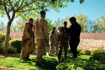 U.S. Marines with Weapons Company, 3rd Battalion, 7th Marine Regiment, 1st Marine Division, present a sniper concealment display to Dominic Heiden, field representative, Environmental Affairs, Marine Corps Air Ground Combat Center (MCAGCC), Twentynine Palms, Calif., during an Earth Day celebration at the home of Marine Air Ground Task Force Training Command / MCAGCC Commanding General Brig. Gen. Roger Turner, April 24, 2019. The event was part of MCAGCC’s annual observance of Earth Day which includes multiple events aimed at fostering awareness of environmental conservation on and around the Marine Corp’s largest training installation. (U.S. Marine Corps photo by Cpl. Dallas Johnson)