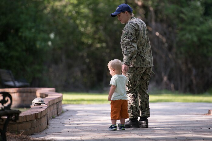 Petty Officer 1st Class Stephanie Clinewell, Nuclear Power Training Unit mineman, and her son Eli spot a turtle on a ledge April 25, 2019, at Azalea Park in Summerville, S.C. The photograph is part of a series recognizing April as Month of the Military Child. Former Defense Secretary Caspar Weinberger first designated the month in 1986 to honor the sacrifices of the military family and to highlight the impact military service can have on children. According to a DOD study, the average child in a military family will change schools six to nine times during a school career. That's an average of three times more frequently than non-military families.
