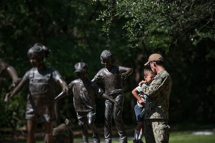 Petty Officer 1st Class Adam M. Potts, Nuclear Power Training Unit mineman, and his son Liam pose for a portrait April 25, 2019, at Azalea Park in Summerville, S.C. The photograph is part of a series recognizing April as Month of the Military Child. Former Defense Secretary Caspar Weinberger first designated the month in 1986 to honor the sacrifices of the military family and to highlight the impact military service can have on children. According to a DOD study, the average child in a military family will change schools six to nine times during a school career. That's an average of three times more frequently than non-military families.