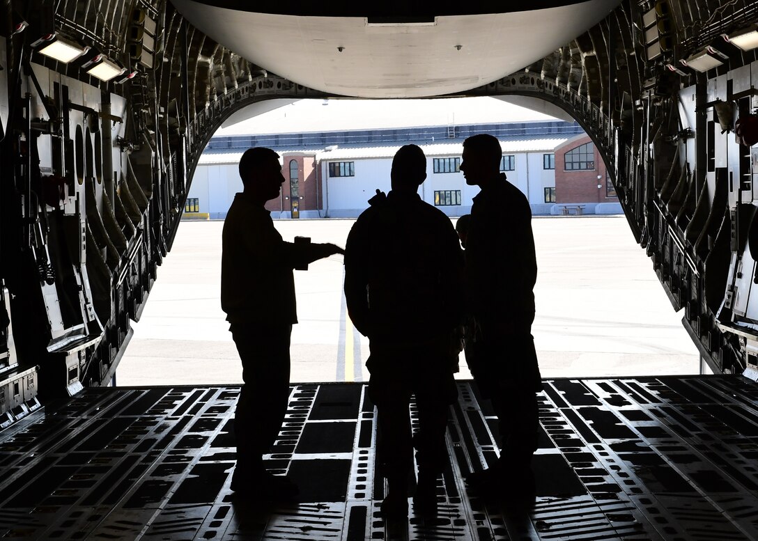 Airmen assigned to the 911th Airlift Wing discuss loading procedures at the Pittsburgh International Airport Air Reserve Station, Pennsylvania, April 11, 2019. Their mission was to retrieve an aircraft tug from Dobbins Air Reserve Base, Georgia.(U.S. Air Force Photo by Senior Airman Grace Thomson)