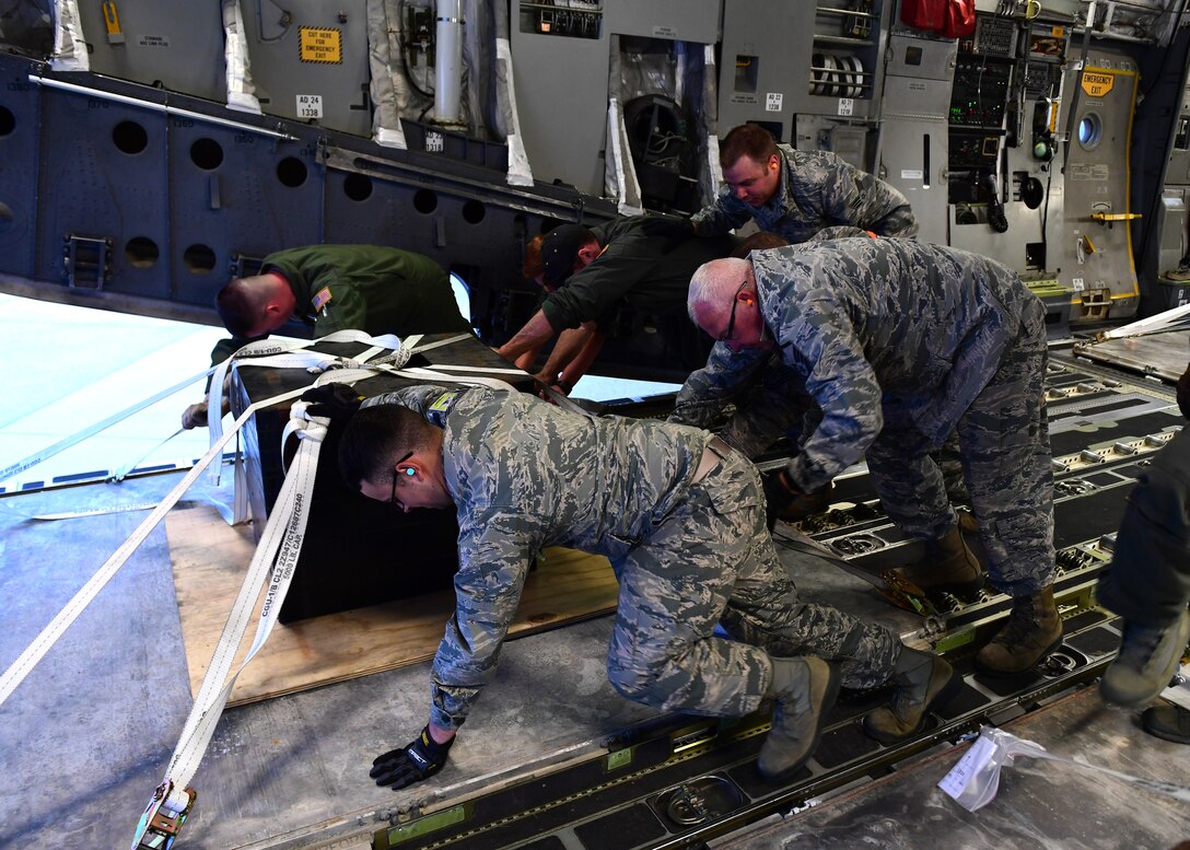 Airmen attached to the 911th Airlift Wing move a counterweights at the Pittsburgh International Airport Air Reserve Station, Pennsylvania, April 11, 2019. The counterweights each weighed approximately 5,000 pounds and were used to balance the aircraft from the aircraft tug.