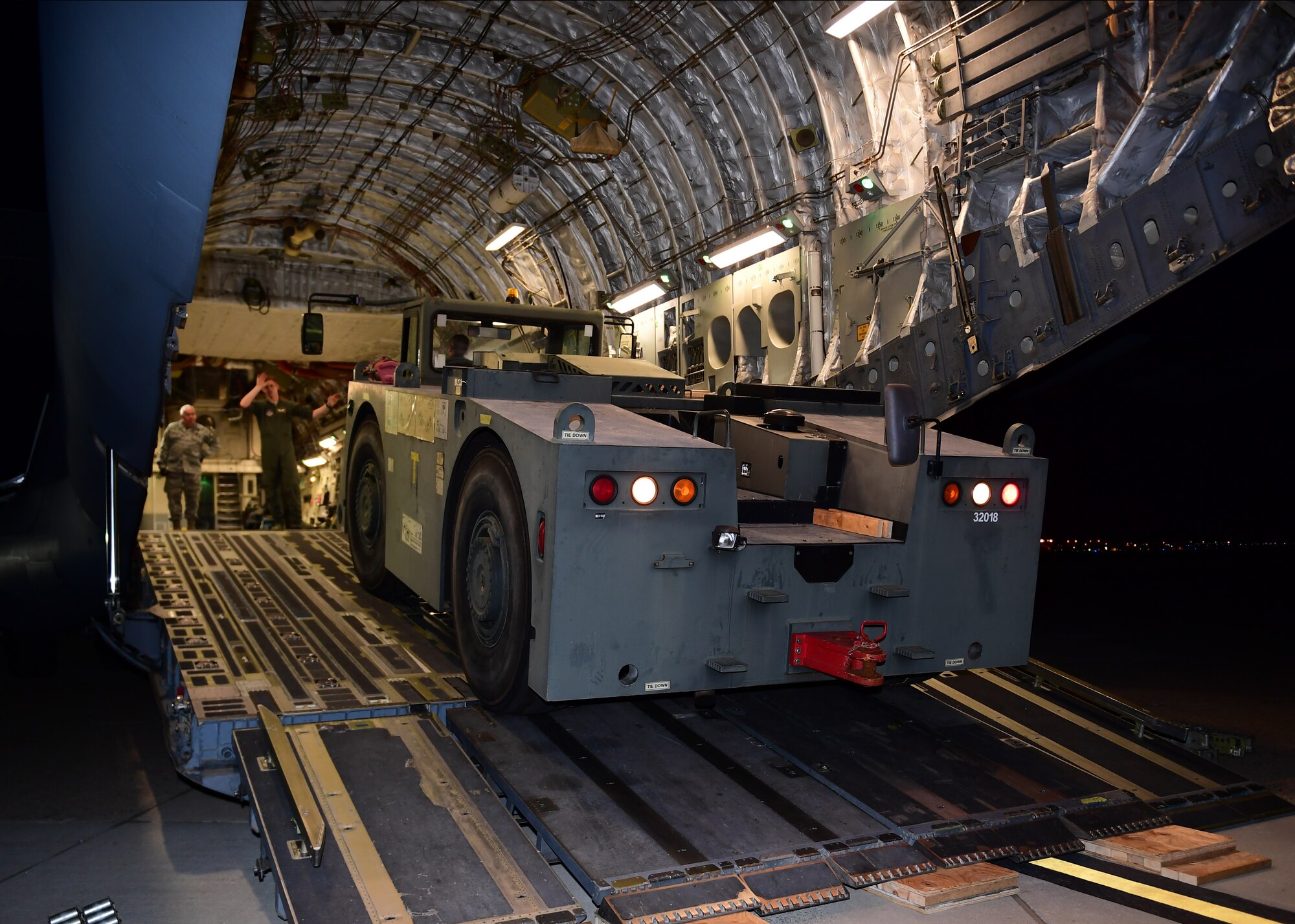 Airmen assigned to the 911th Airlift Wing drive a aircraft tug, which is used to move extremely heavy aircraft,onto the flightline at the Pittsburgh International Airport Air Reserve Station, Pennsylvania, April 11, 2019. Their mission to retrieve the aircraft tug was a success and it arrived safely to the 911th AW, its new home.(U.S. Air Force Photo by Senior Airman Grace Thomson)