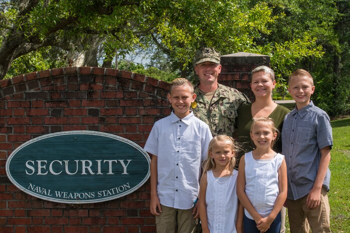 Petty Officer 1st Class Kaylen Potter, 628th Security Forces Squadron flight chief, and his kids, Nixon, Noah, Reilyn and Jersie, and his wife, Jenny, pose for a portrait April 26, 2019 at Joint Base Charleston, S.C.