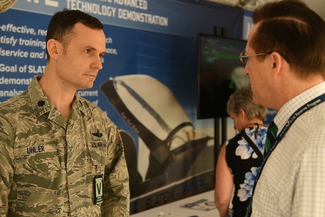 Service member speaking to a man.