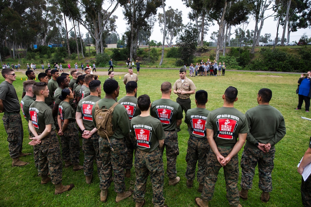 Lt. Col. Alan J. Clarke, commanding officer of Headquarters and Headquarters Squadron, Marine Corps Air Station Miramar, addresses the Marines after a fitness challenge session at Miramar Ranch Elementary School in San Diego, April 26. The Marines came together for the Single Marine Program’s 5th annual “Days of Service” event, which involves Marines going to different locations off of the installation and doing their part in keeping the environment clean. (U.S. Marine Corps photo by Cpl. Preston Hightower)
