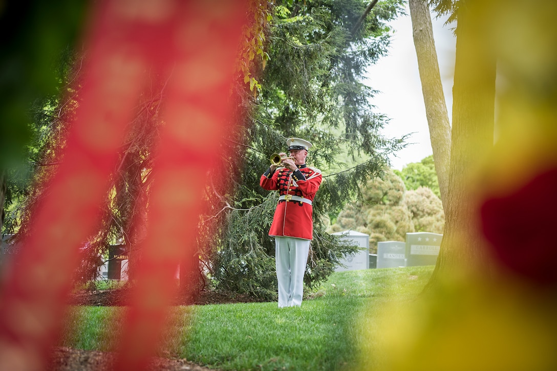 A bugler plays taps.