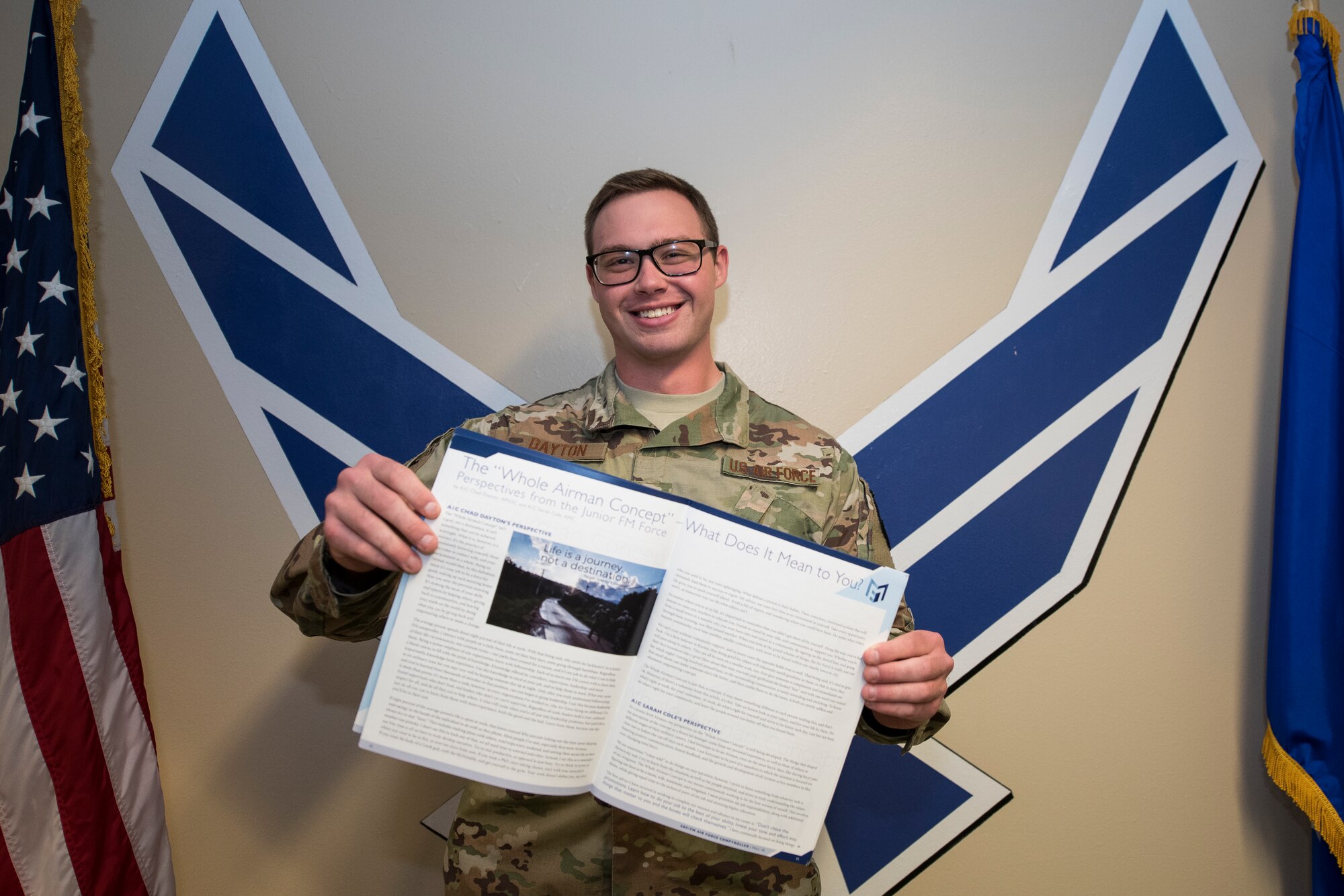 Airman 1st Class Chad Dayton, 27th Special Operations Comptroller Squadron financial operations technician, holds open a printed copy of the article he wrote for a comptroller magazine at Cannon Air Force Base, N.M., Apr. 23, 2019. Dayton received the Special Operations Command Financial Management Outstanding Author Award for the article