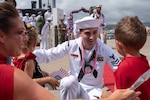 A Sailor assigned to the Los Angeles-Class fast-attack submarine USS Santa Fe (SSN 763) greets his family after he arrived at Joint Base Pearl Harbor-Hickam, after completing his latest deployment, April 22. (U.S. Navy Photo by Mass Communication Specialist 1st Class Daniel Hinton)