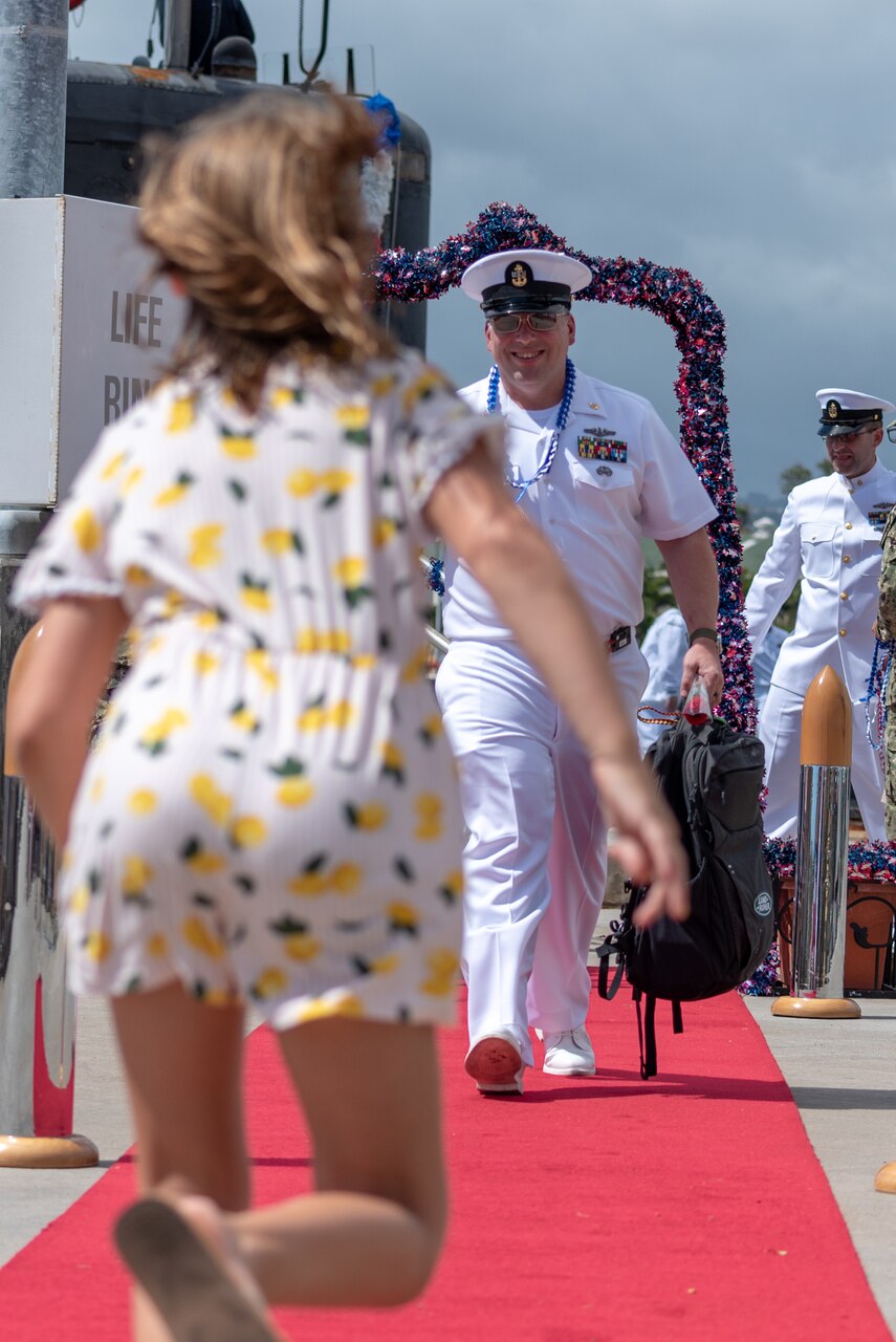PEARL HARBOR -- A Sailor assigned to the Los Angeles-Class fast-attack submarine USS Santa Fe (SSN 763) greets his family after arriving at Joint Base Pearl Harbor-Hickam, after completing their latest deployment, April 22. (U.S. Navy Photo by Mass Communication Specialist 1st Class Daniel Hinton)