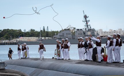 PEARL HARBOR -- A Sailor assigned to the Los Angeles-Class fast-attack submarine USS Cheyenne (SSN 773) casts a line as the ships arrives at Joint Base Pearl Harbor-Hickam, after completing their latest deployment, April 26. (U.S. Navy Photo by Mass Communication Specialist 1st Class Daniel Hinton)