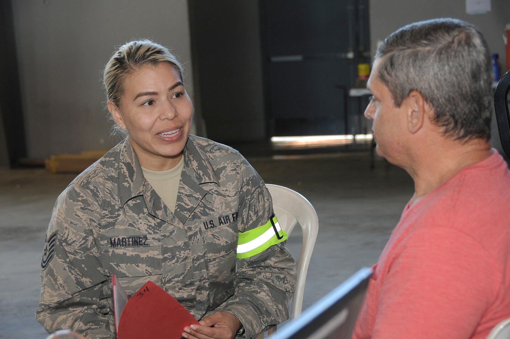 Omaha Nebraska resident Technical Sgt. Jessica Martinez 185th Air Refueling Wing Medical Group, Iowa Air National Guard, talks with a patient at the site of care in Ponce, Puerto Rico on April 29, 2019.