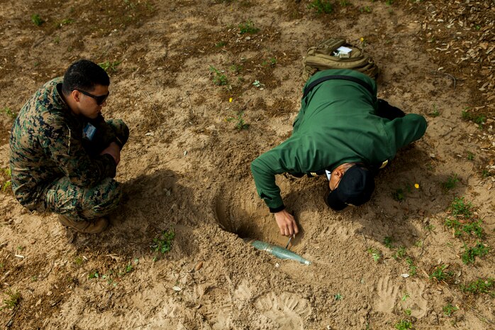 A U.S. Marine with Special Purpose Marine Air-Ground Task Force-Crisis Response-Africa 19.2, Marine Forces Europe and Africa, discusses explosive ordnance identification procedures with a member of the Moroccan Royal Armed Forces during Humanitarian Mine Action training at Unite de Secours et Sauvetage’s Base, Kenitra, Morocco, April 22, 2019. The Moroccan soldiers trained alongside the U.S. Marines in order to identify and properly dispose of explosive ordnance. SPMAGTF-CR-AF is deployed to conduct crisis-response and theater-security operations in Africa and promote regional stability by conducting military-military training exercises throughout Europe and Africa. (U.S. Marine Corps photo by Capt. Clay Groover)