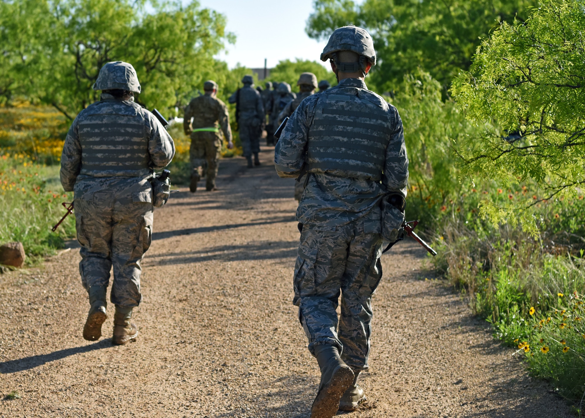 Angelo State University Air Force ROTC Cadets march in a tactical formation back to their forward operating base Camp Sentinel during their field training exercise at Goodfellow Air Force Base, Texas, April 25, 2019. ROTC students moved in fire teams and completed simulated missions including attacks and reconnaissance. (U.S. Air Force photo by Airman 1st Class Ethan Sherwood/Released)